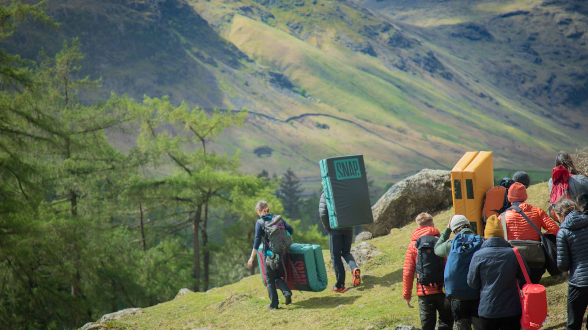 Un grupo disfruta de una clínica de boulder en la montaña